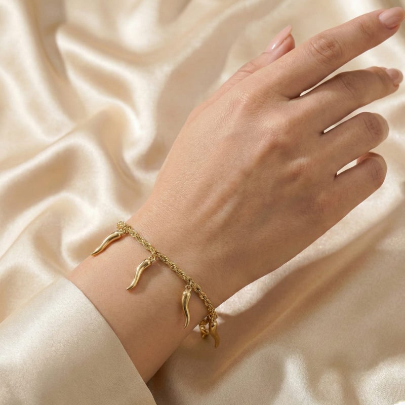 A stylish gold bracelet made of rust-resistant stainless steel, with a braided "rope" design from which attractive "pepper horn" pendants dangle, with an adjustable clasp to fit you. - Image 3